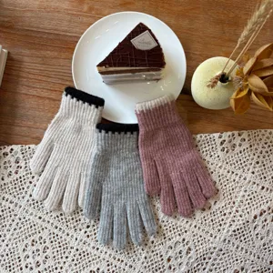 Detailed view of cozy knit winter gloves in multi colors, soft warm accessory for cold days.