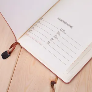 Detailed view of A5 leather business notebook personal data page and bookmark detail.