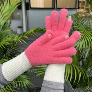 Detailed view of pink knit fingerless gloves with long ribbed cuffs, cozy autumn and winter wear.