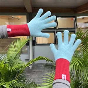 Stylish knitted wool gloves featuring split fingers and long contrasting red cuffs for warmth.