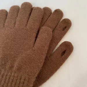 Brown knitted touchscreen gloves detail view, soft wool texture and convenient finger openings.