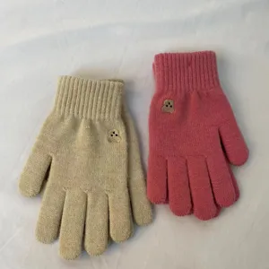 Cozy winter knit gloves with cute bear embroidery, warm touch screen split finger design.