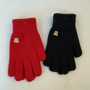 Detailed view of winter warm knit gloves featuring cute bear embroidery in red and black.
