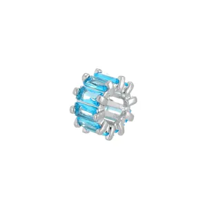 Close-up of a silver spacer bead with channel-set baguette blue cubic zirconia stones.