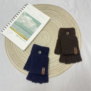 Detailed view of winter knitted convertible half-finger gloves in dark blue and brown colors.