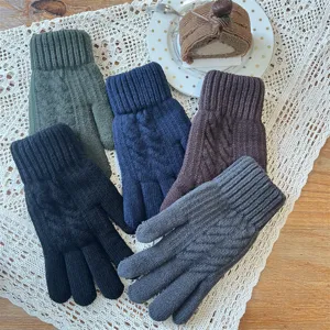 Gros plan détaillé des gants tactiles tricotés pour hommes d'hiver sur nappe en dentelle.