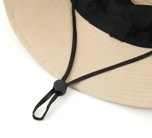 Close-up detail of outdoor sun hat breathable mesh lining and adjustable chin strap.