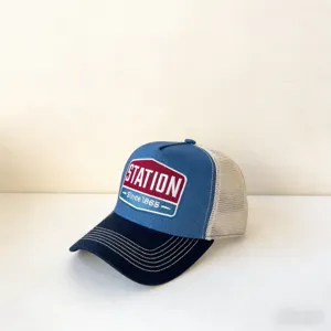 Retro style mesh baseball hat featuring station patch and contrast stitched brim.