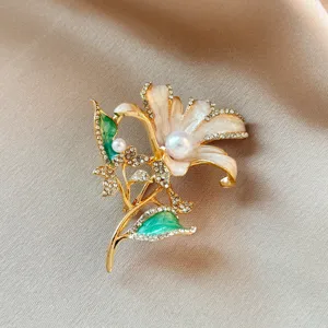 Exquisite lily flower brooch detail, featuring sparkling rhinestones and elegant faux pearls.
