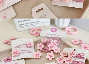 Detailed view of pink cherry blossom floral hair clips and elastic hair ties set for girls