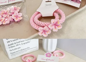 Detailed macro view of pink cherry blossom hair ties and floral clips for styling