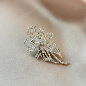 Silver rhinestone brooch back detail showing pin clasp on elegant satin background jewelry accessory