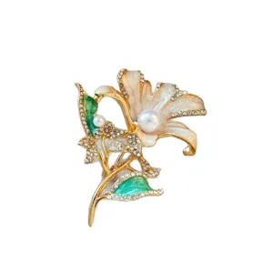 Elegant gold-tone lily flower brooch with faux pearls, rhinestones, and colorful enamel details.