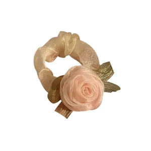 Elegant pink rose flower organza scrunchie with gold leaf accents for hair styling.