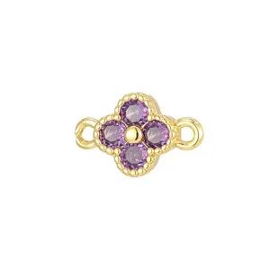 Close-up of a golden clover jewelry connector set with four purple zircon stones
