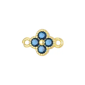 Close-up of gold clover jewelry connector with blue zircon and double loops