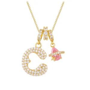 Close-up view of gold-plated necklace with full-drill letter C and pink planet star pendant