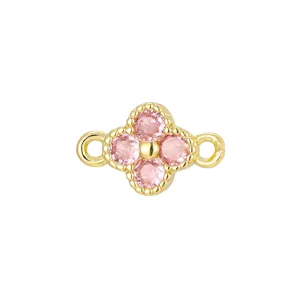 Detailed macro view of a gold-plated four-leaf clover charm set with four pink zircons