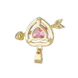 Macro view of gold-plated Cupid's arrow pendant with pink heart gemstone