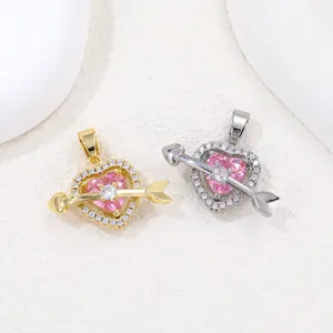 Detail view of pink heart-shaped Cupid arrow pendants with sparkling pavé crystals