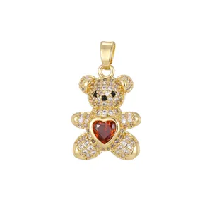 Macro detail of a golden teddy bear pendant featuring micro-paved cubic zirconia and a red heart
