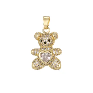 Close-up of a gold-tone teddy bear pendant with sparkling micro-pave CZ and heart stone