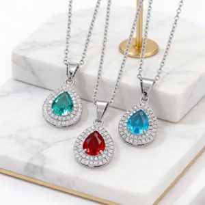 Detail view of elegant teardrop zircon necklaces in green, red and blue.
