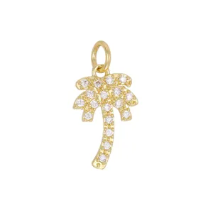 Detailed close-up of an 18K gold-plated palm tree pendant with sparkling zircons