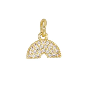 Detailed macro view of a 18K gold-plated rainbow charm inlaid with cubic zirconia