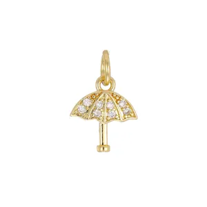 Detailed close-up view of a gold-plated umbrella pendant with cubic zirconia inlays.