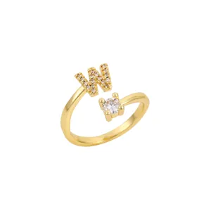 Vue détaillée d'une bague dorée avec une lettre W sertie et un cristal rond brillant