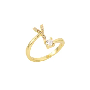 Détail en gros plan d'une bague ouverte dorée minimaliste ornée d'une lettre K sertie
