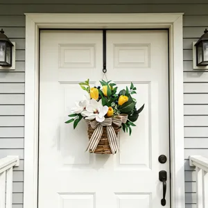 Spring flower basket with artificial white magnolias and yellow tulips on a white door