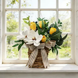 Detail of artificial magnolia and tulip floral basket with farmhouse striped bow