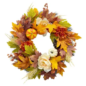 Detailed view of an autumn wreath featuring maple leaves, mini pumpkins and peonies.