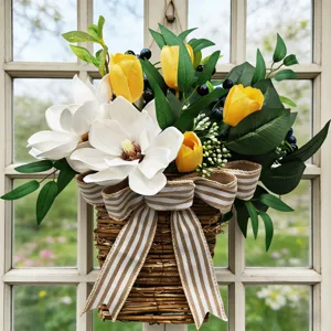 Close-up of artificial magnolia and tulip basket with striped ribbon for door decor.
