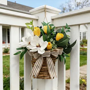 Spring artificial magnolia and tulip flower basket hanging on a white farmhouse fence