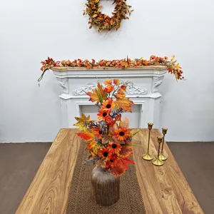 Autumn harvest centerpiece with sunflowers and maple leaves in a rustic vase on a table