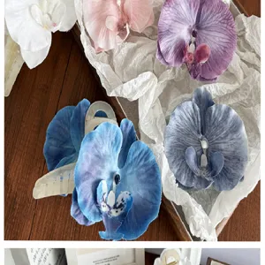 Detailed view of large orchid fabric hair claw clips in various pastel colors