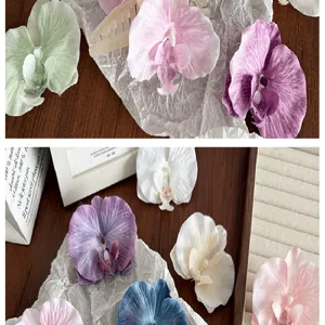 Close-up detail of large silk orchid hair claw clips with ethereal crumpled fabric petals