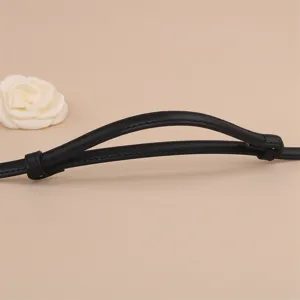 Black leather belt detail showcasing fine stitching and quality texture for women fashion.