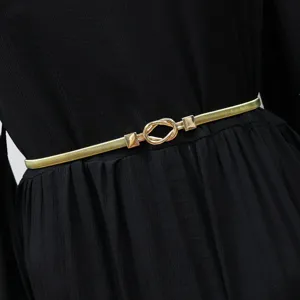 Gold metal elastic waist belt detail close up, stylish dress accessory for women and girls.