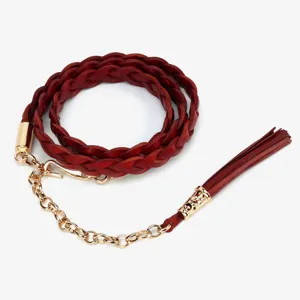 Close-up of dark red braided leather waist chain with gold metal chain and tassel detail.