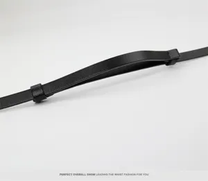 Black genuine leather slim belt detail shot, versatile accessory for dresses and sweaters.