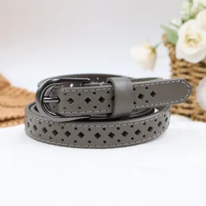 Detail view of a stylish grey women's hollow leather belt with dark metal buckle feature.