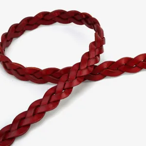 Genuine leather braided waist belt detail shot, slim red strap for women clothing decoration.