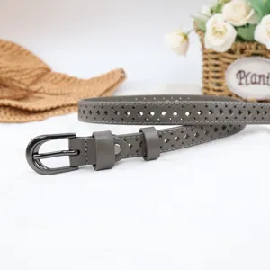Hollow out leather belt detail, grey thin strap with metal buckle and diamond punch holes.