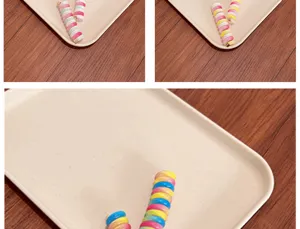 Detailed close-up of colorful spiral telephone wire hair ties on a cream display tray