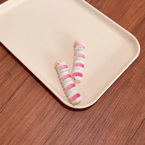 Stylish colorful DIY telephone wire hair coils for bubble braids on minimalist beige tray