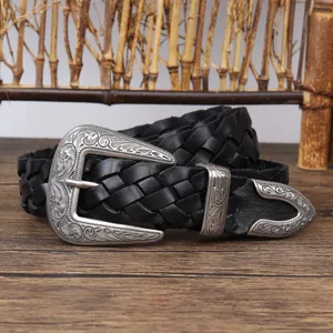 Close-up detail of vintage black woven leather belt with ornate silver floral buckle